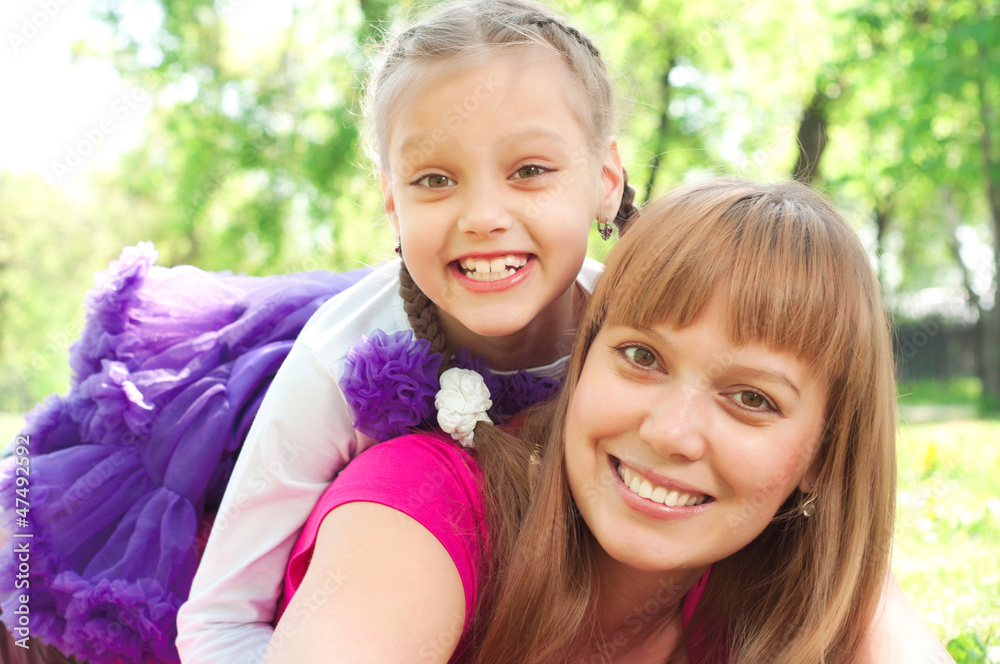 mother and daughter playing on grass