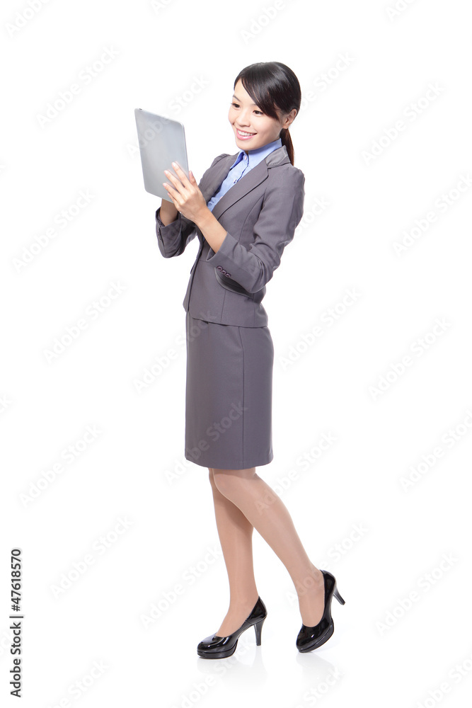 Business woman using tablet PC in full length