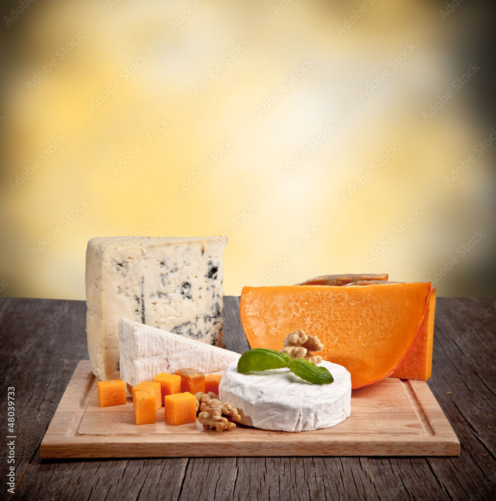 Delicious fresh french cheeses served on wooden table