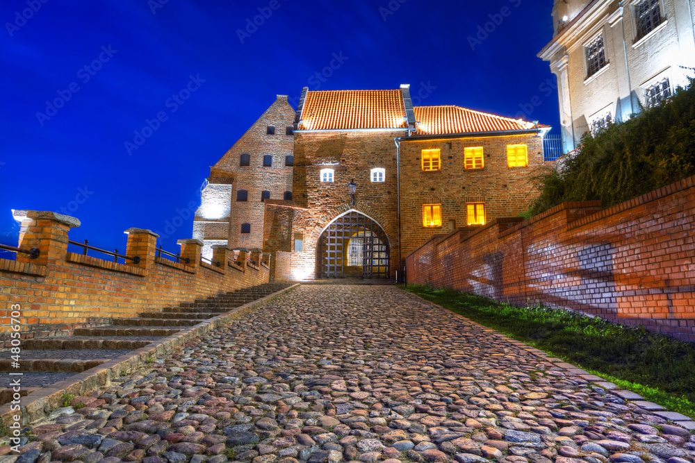 Granaries with water gate in Grudziadz at night, Poland