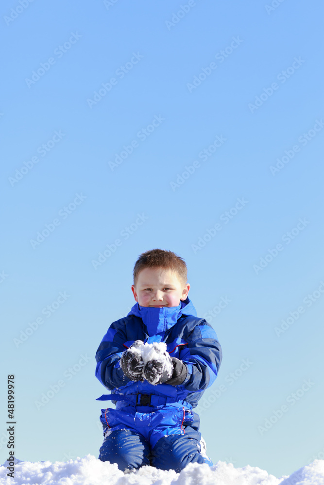 boy holding snow