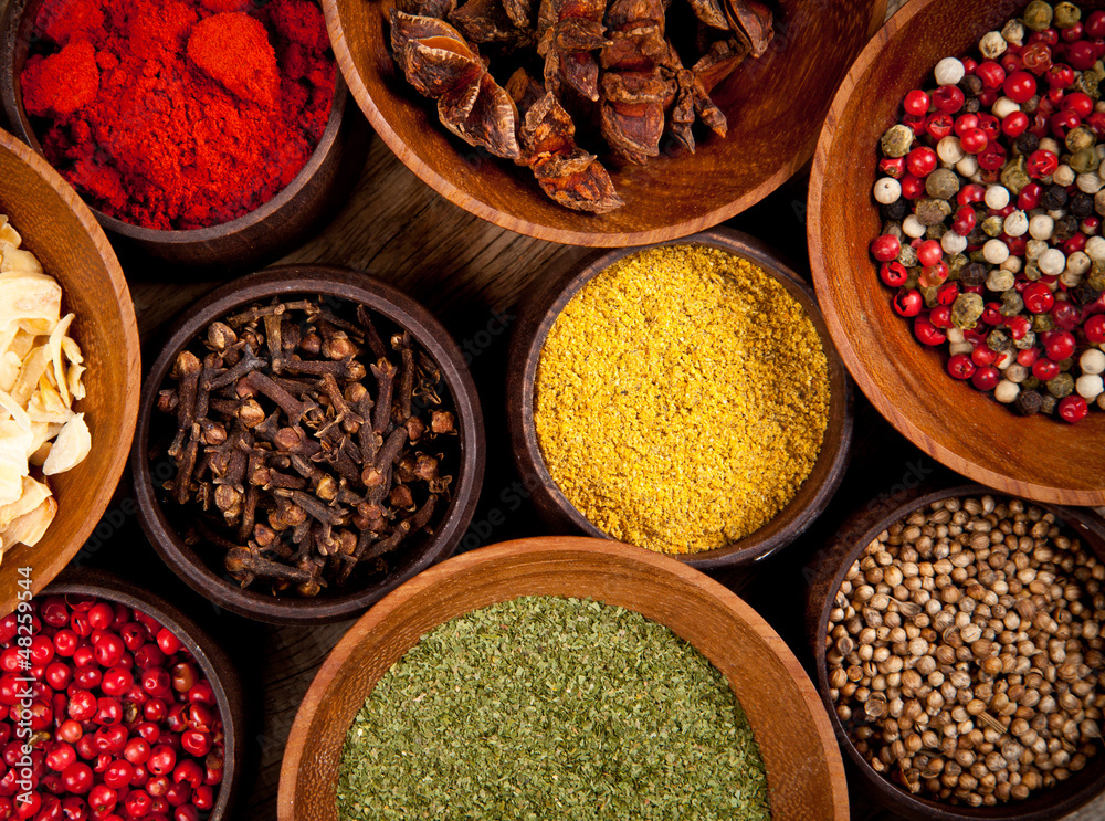 Various kind of spices in wooden bowls