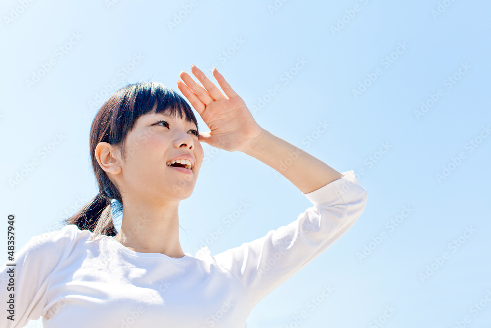 a young asian woman relaxing in the blue sky