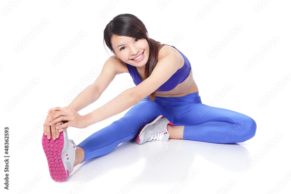 Fit woman stretching her leg to warm up