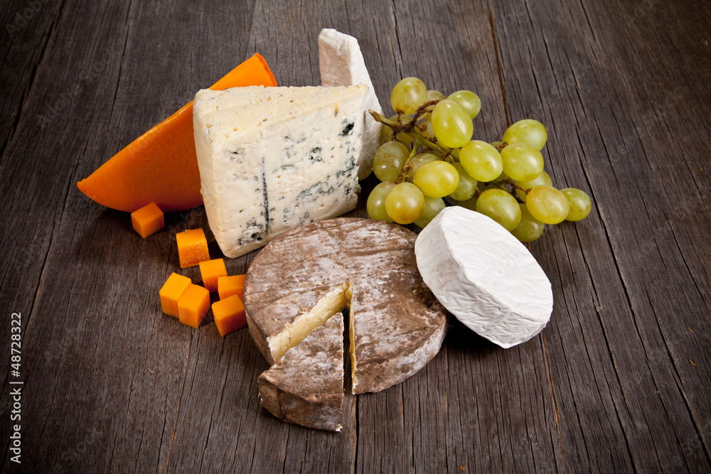  Delicious fresh french cheeses served on wooden table