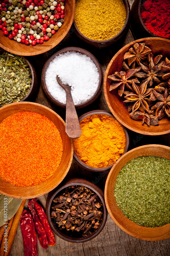  Various kind of spices in wooden bowls