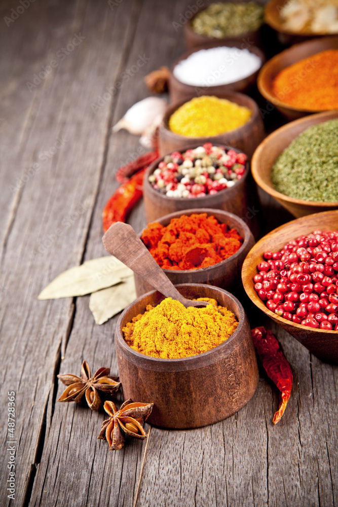  Various kind of spices in wooden bowls