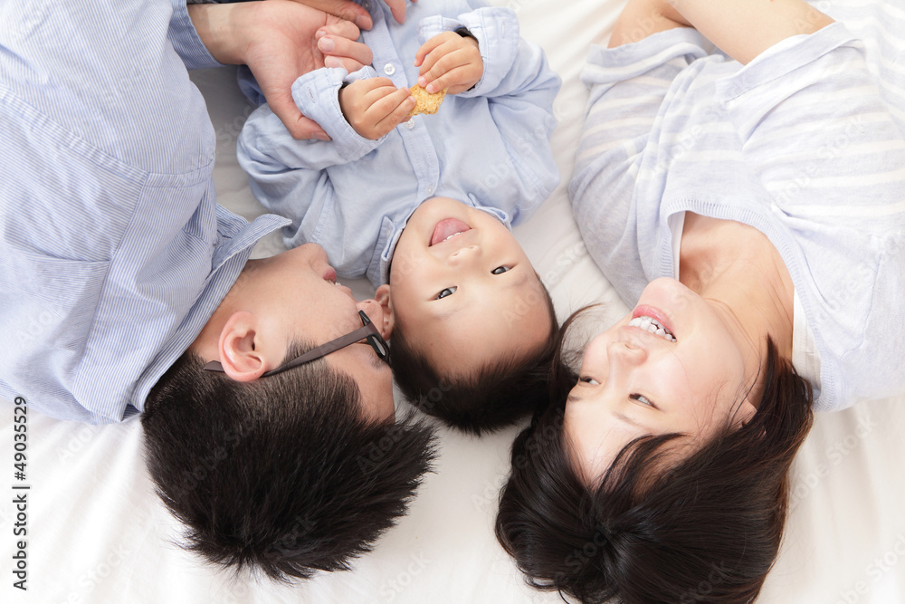 Happy family with children in bed