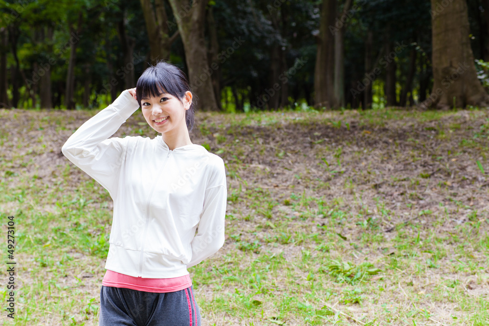 attractive asian woman relaxing in the park