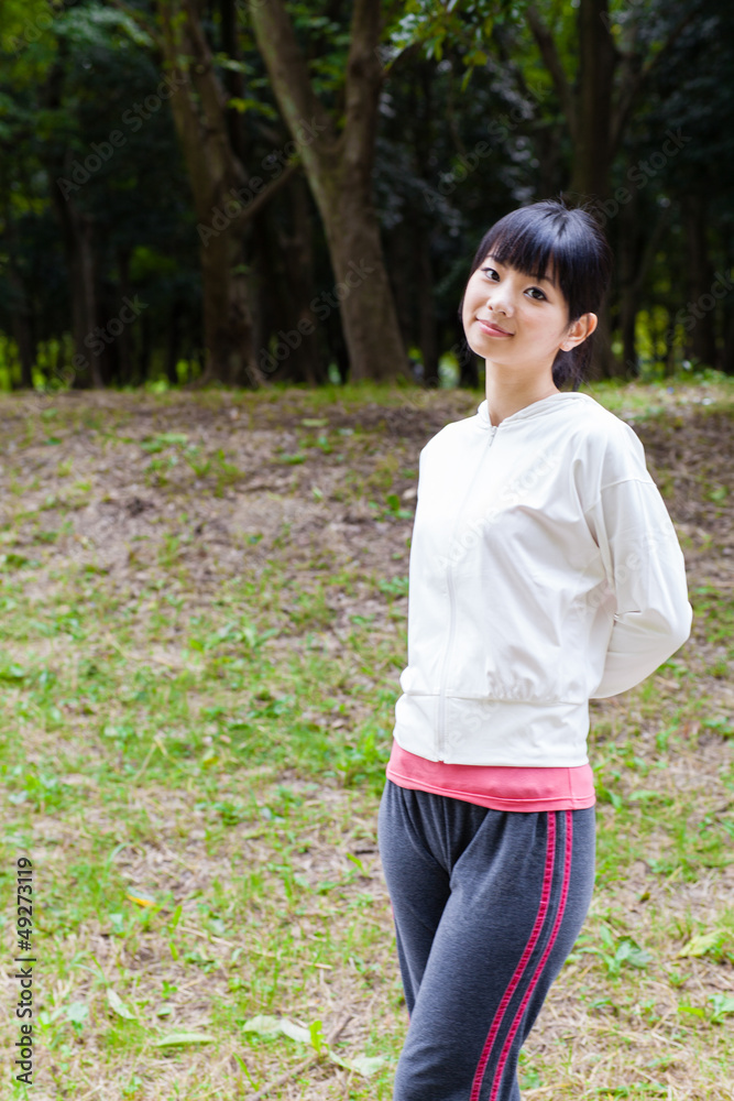 attractive asian woman relaxing in the park