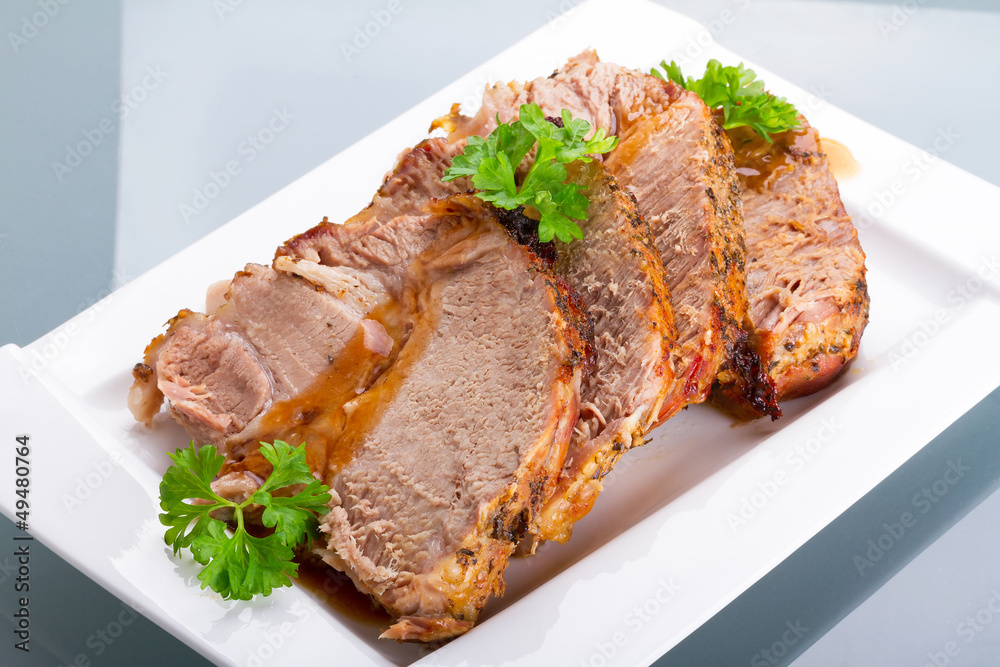 Slices of homemade roast pork on the plate