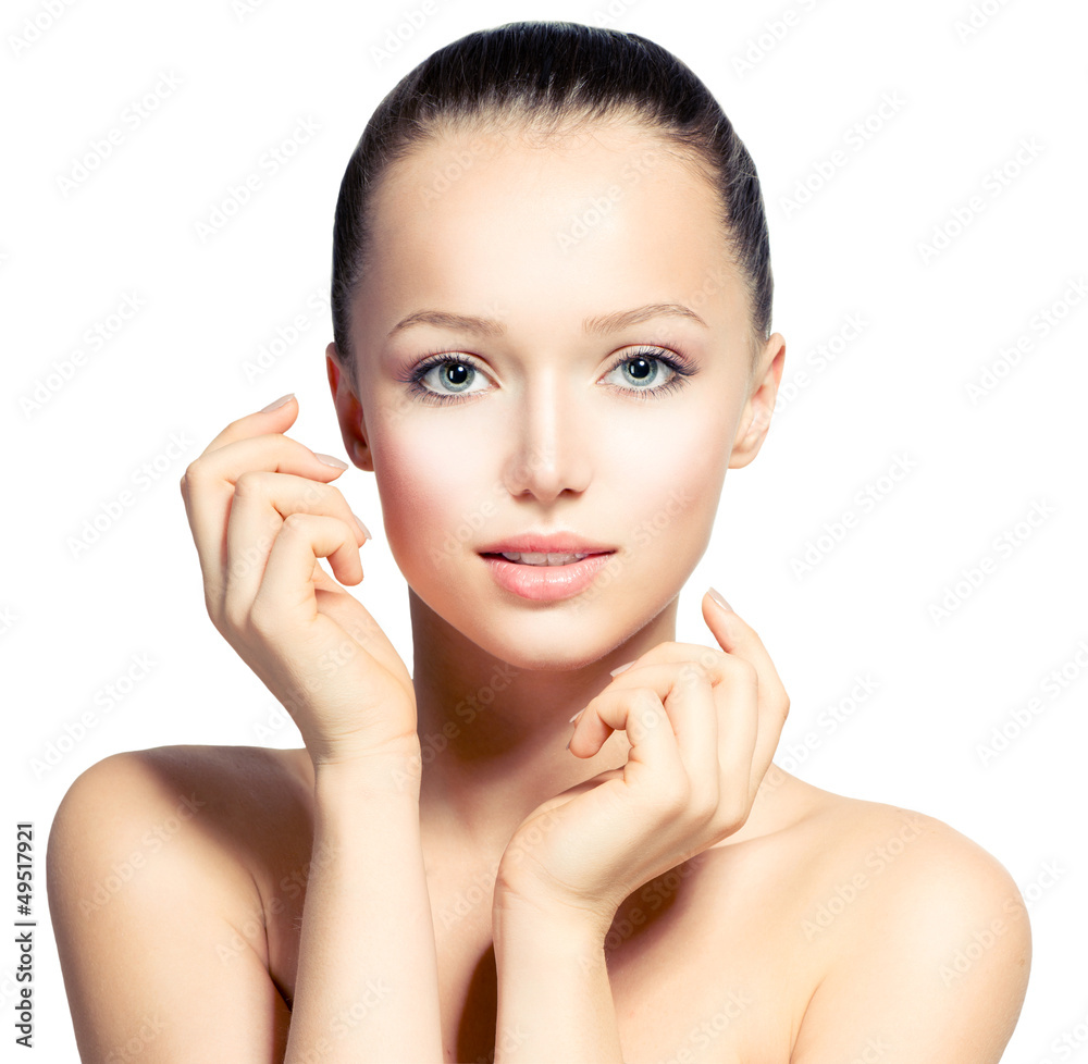 Beautiful Young Woman with Fresh Clean Skin touching her Face