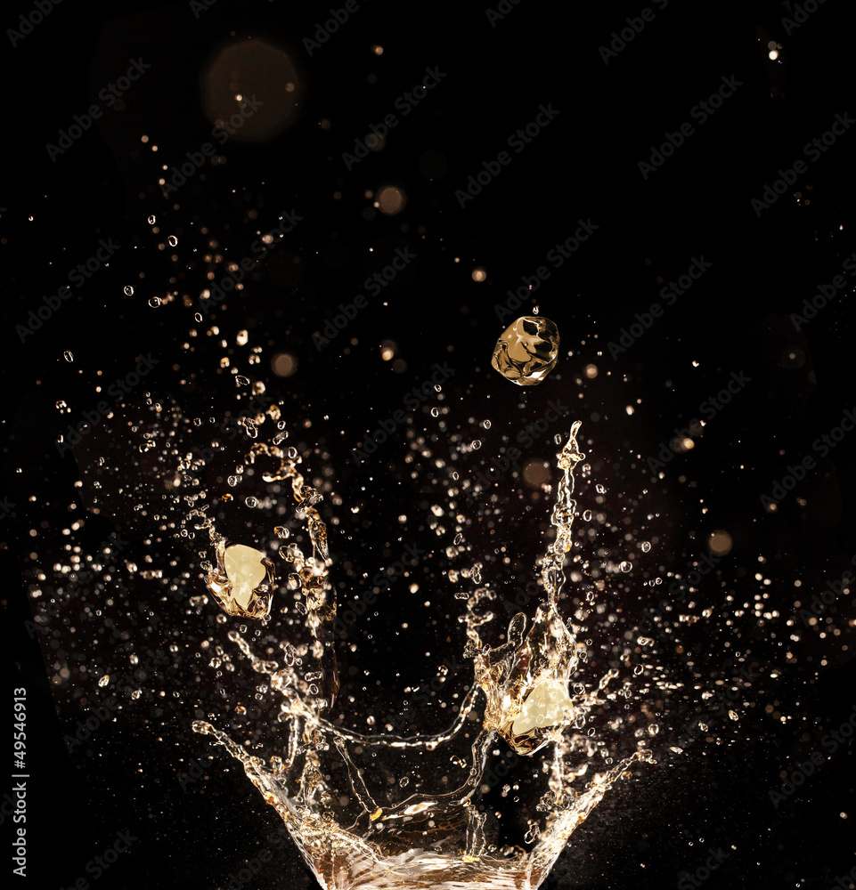 Whiskey splash isolated on black background