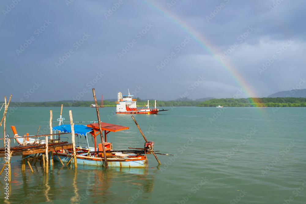 Rainbow and boat on the river at Koh Kho Khao in Thailand