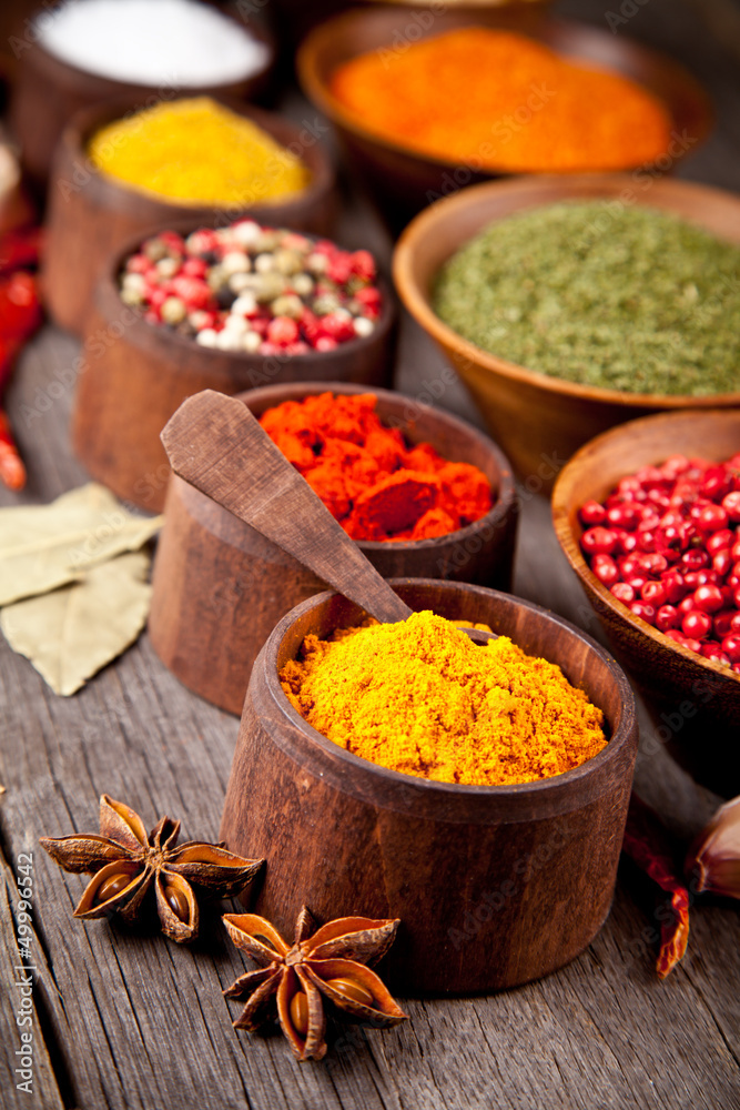  Various kind of spices in wooden bowls