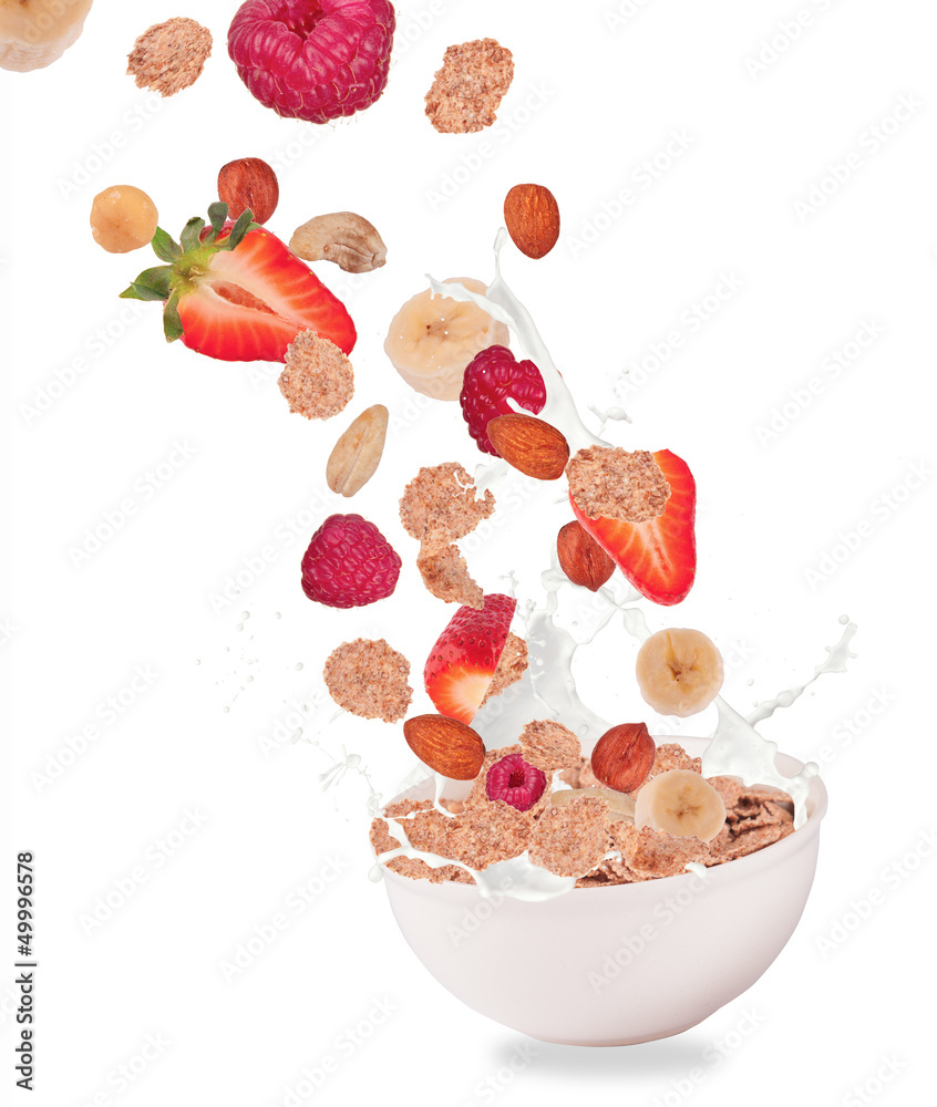 Healthy food and milk with flying cereals and fruit on white