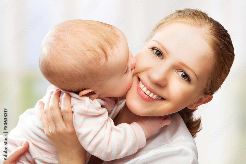 Happy cheerful family. Mother and baby kissing