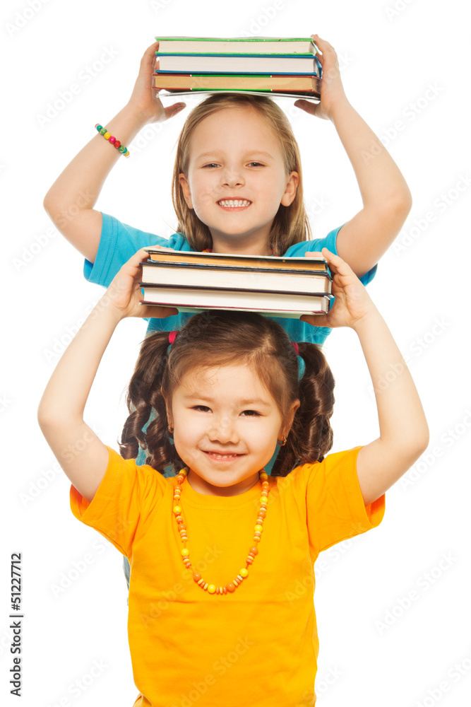 Smart girls with pile of books