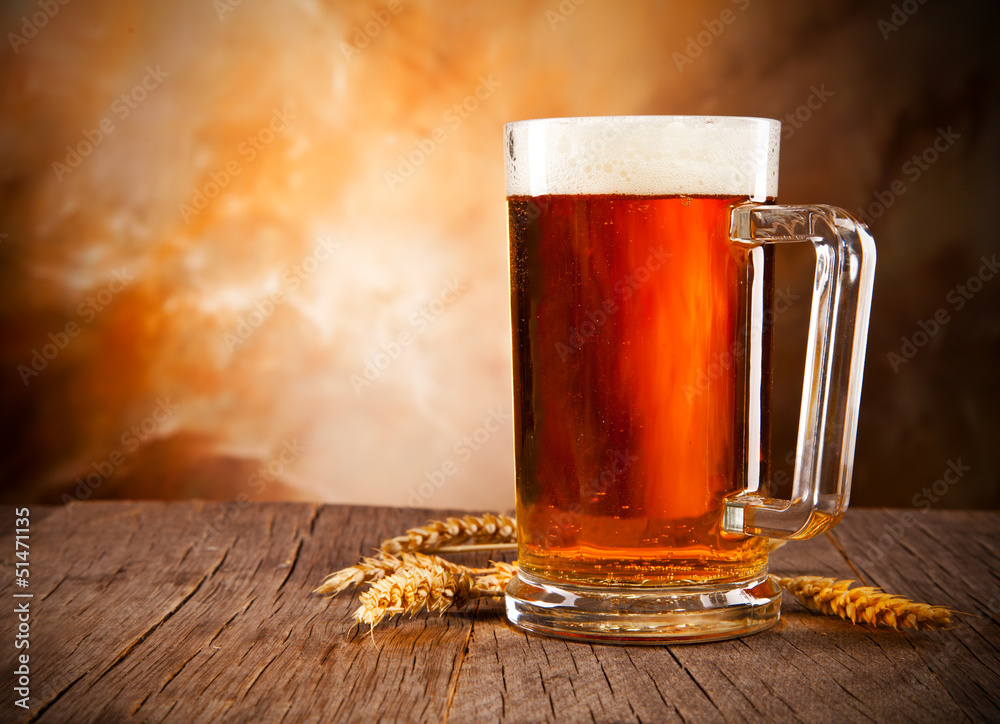 Glass of beer on wooden table