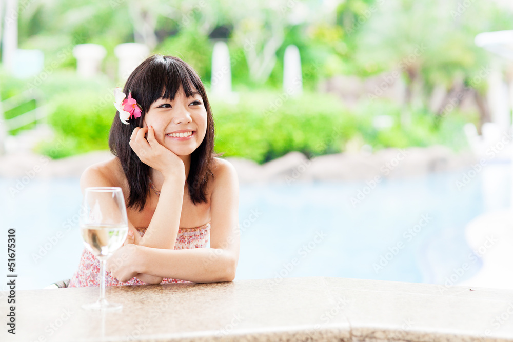 a young asian woman relaxing in the resort hotel