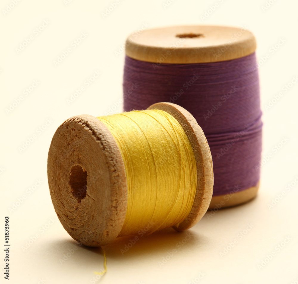 Thread bobbins on white background