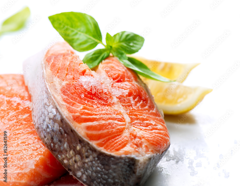 Raw Salmon Red Fish Steak with Herbs and Lemon isolated on White