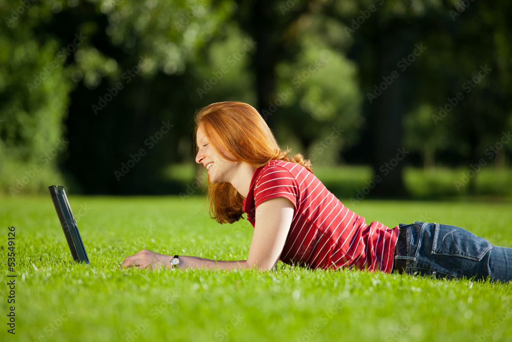 Woman with computer in a park