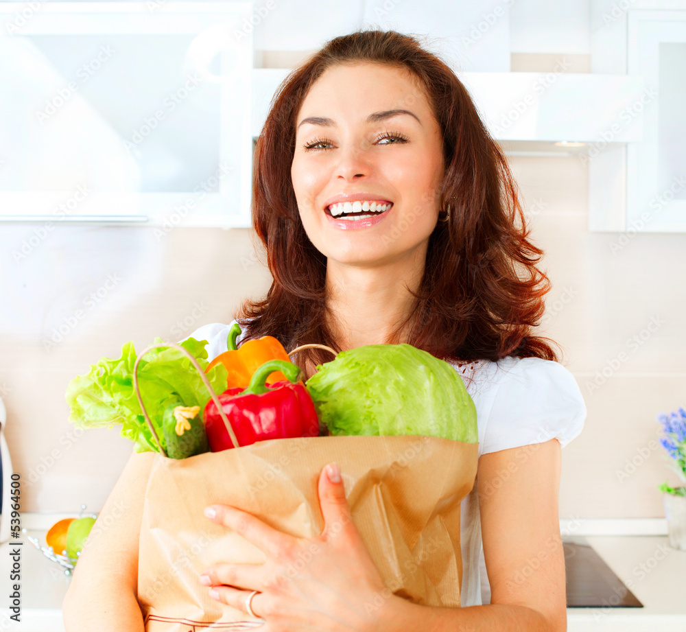 Happy Young Woman with vegetables in shopping bag. Diet Concept