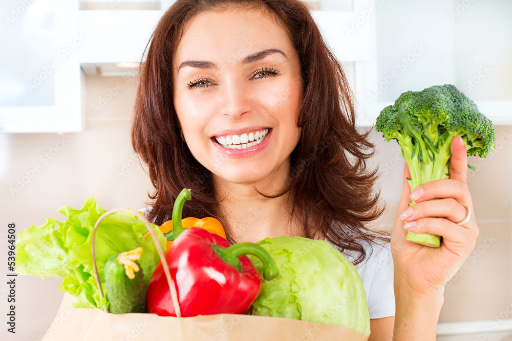 Happy Young Woman with vegetables in shopping bag. Diet Concept