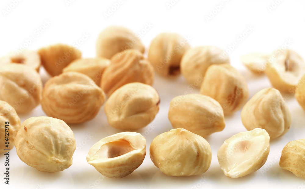 Closeup view of hazelnuts over white background