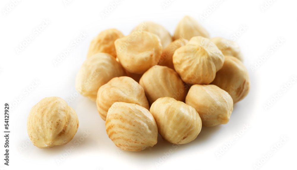 Closeup view of hazelnuts over white background