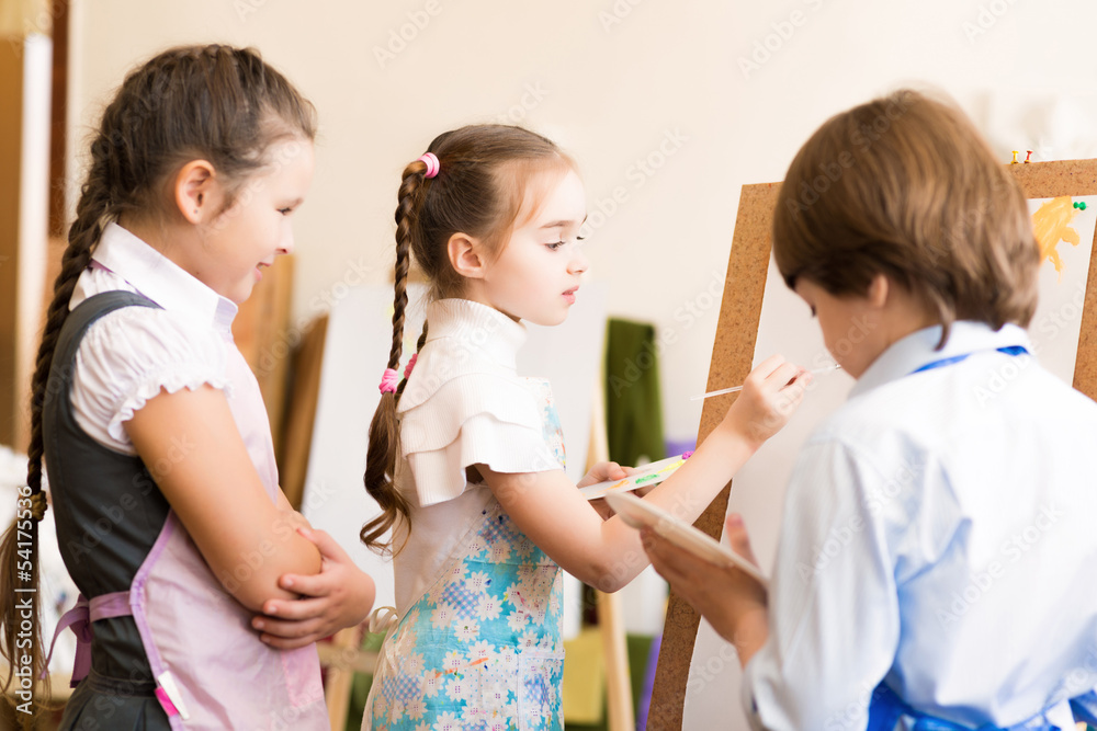 children draw pictures of easels