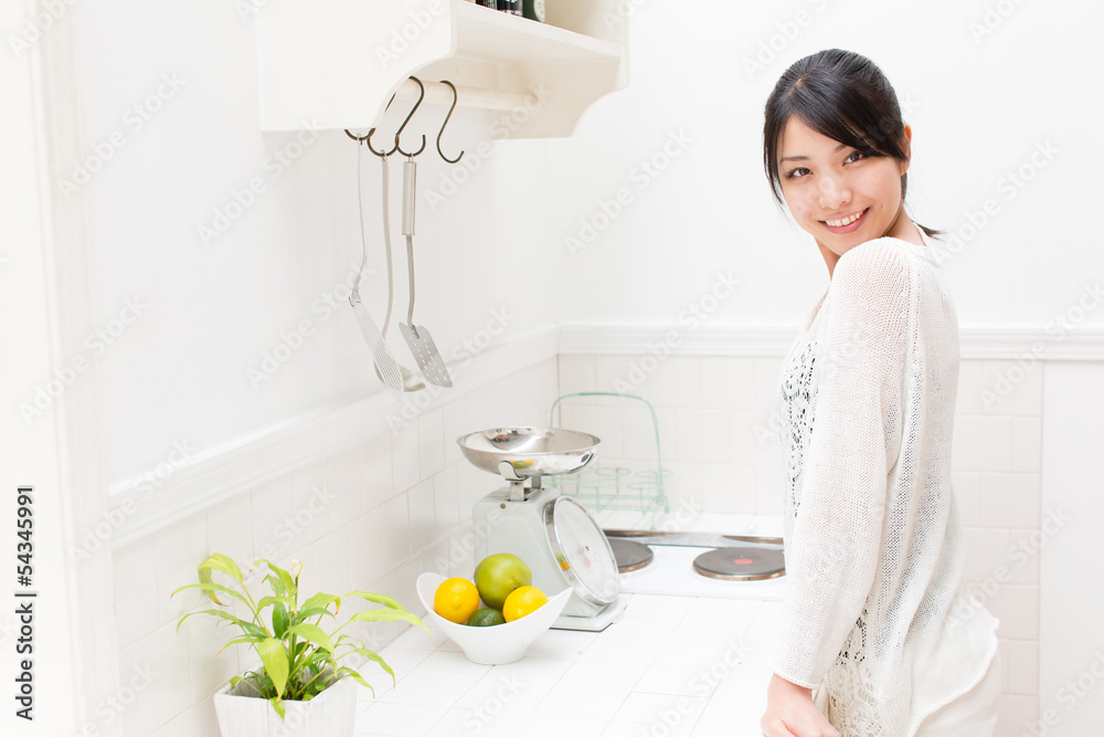 young asian woman relaxing in the kitchen