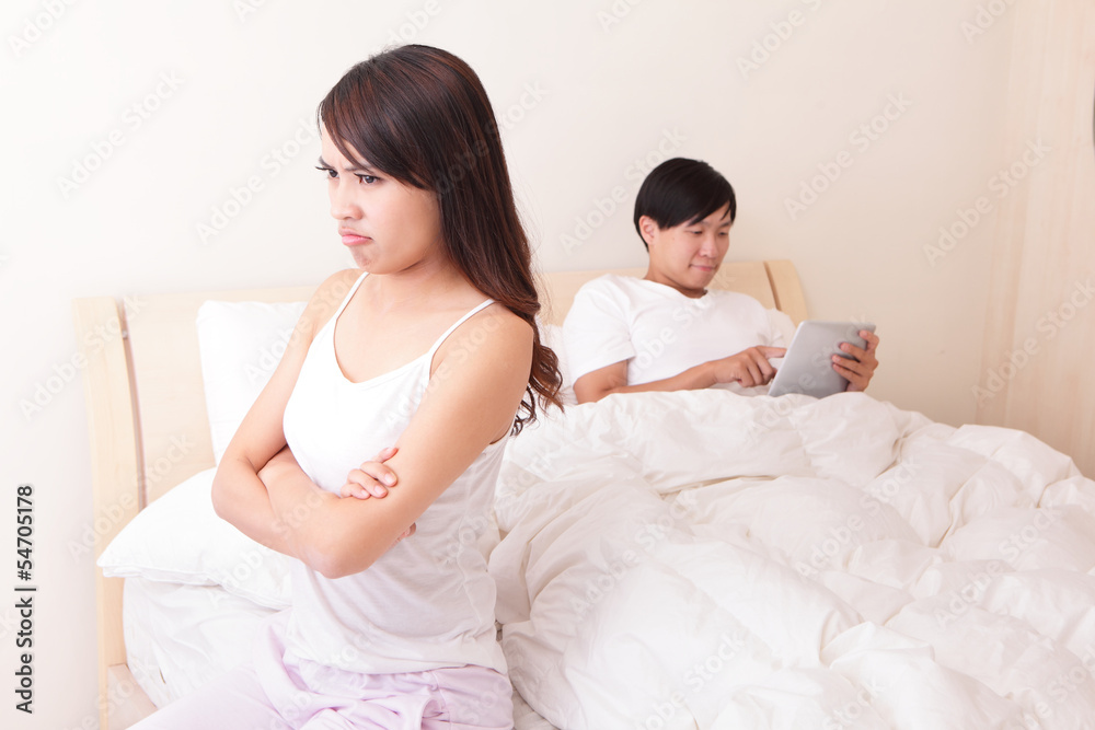 Couple with tablet pc iin bed