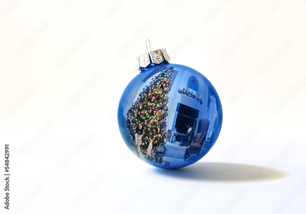 Shiny Blue Holiday Ornament Reflects Bright Christmas Tree