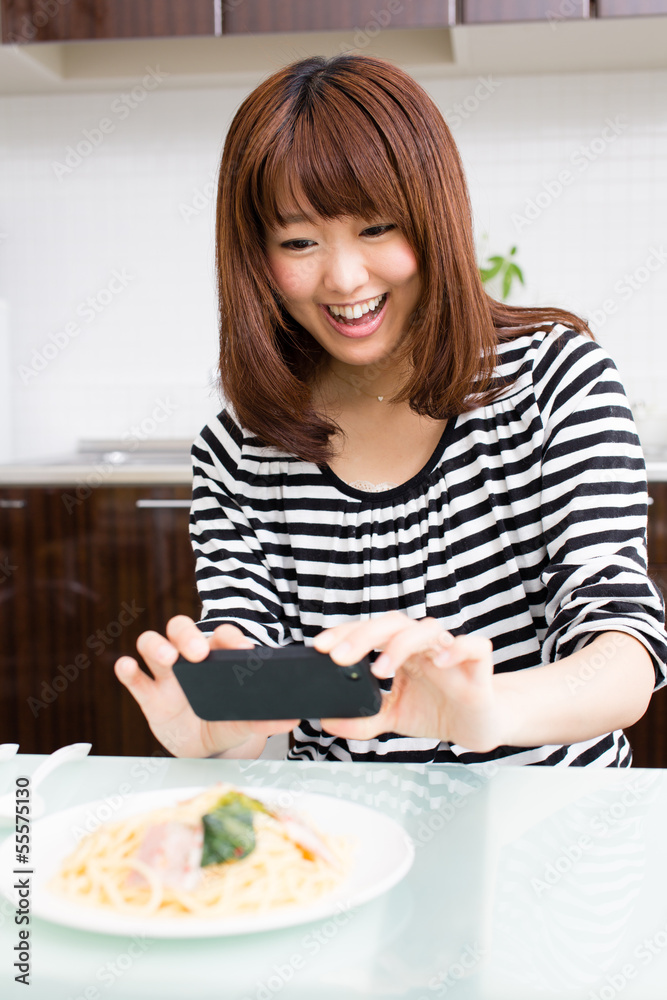 young asian woman relaxing in the kitchen