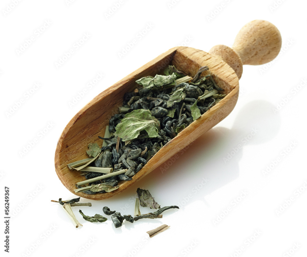 wooden scoop with green tea and mint