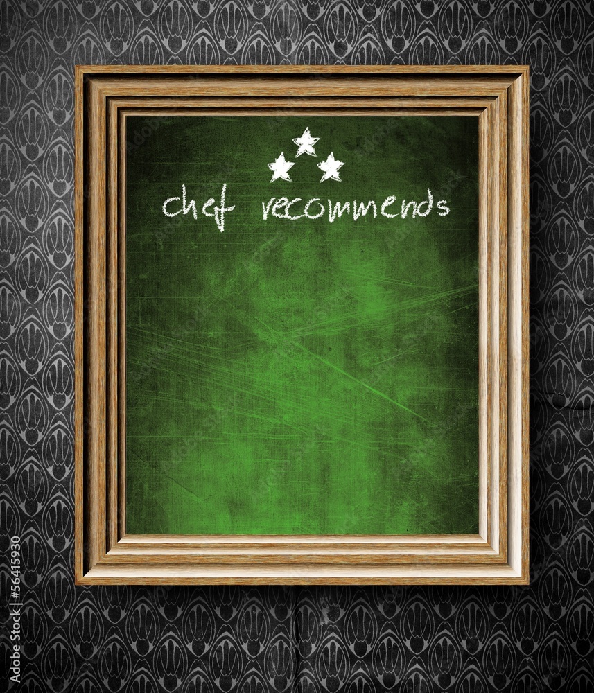 Chef recommends with copy-space chalkboard in old wooden frame