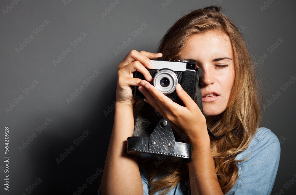 Photographer woman holding old camera, taking pictures