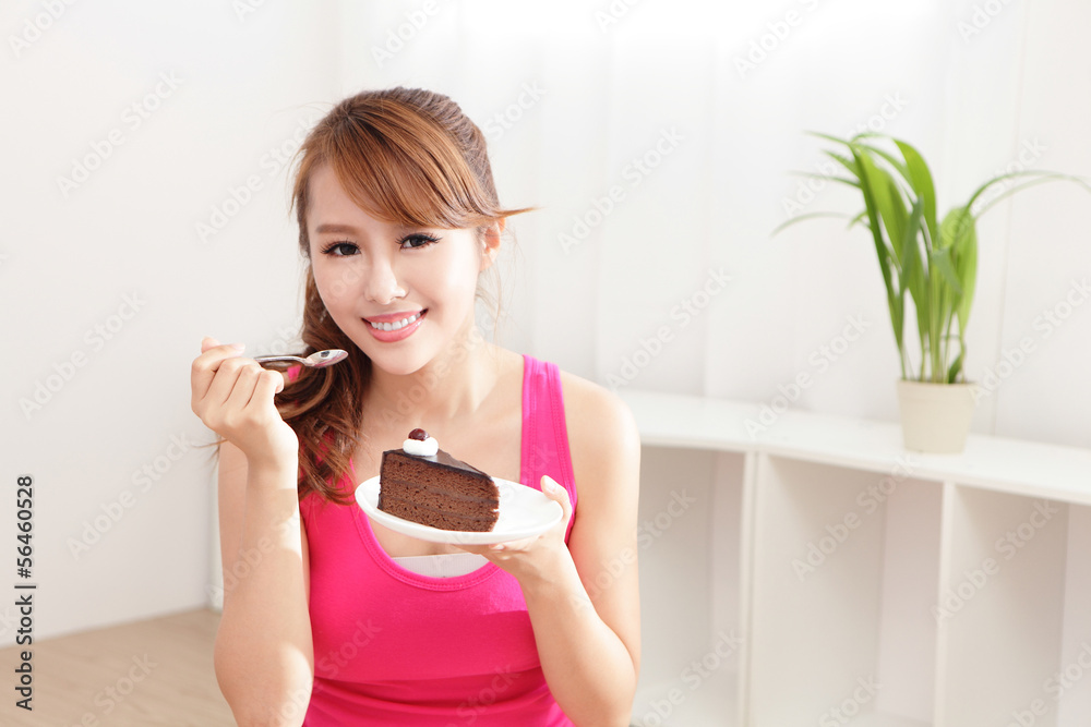 happy woman smiles eating chocolate cake