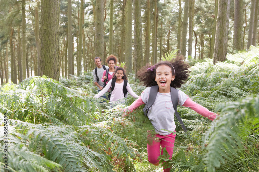 Family Group Hiking In Woods Together