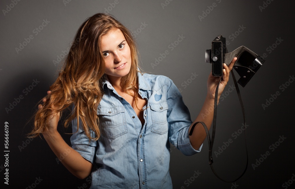 Photographer woman taking pictures herself with old camera