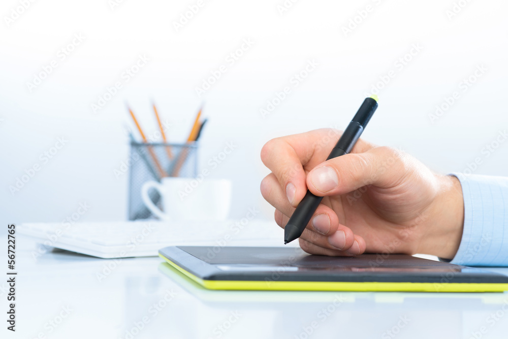 Designer hand drawing a graph on the tablet