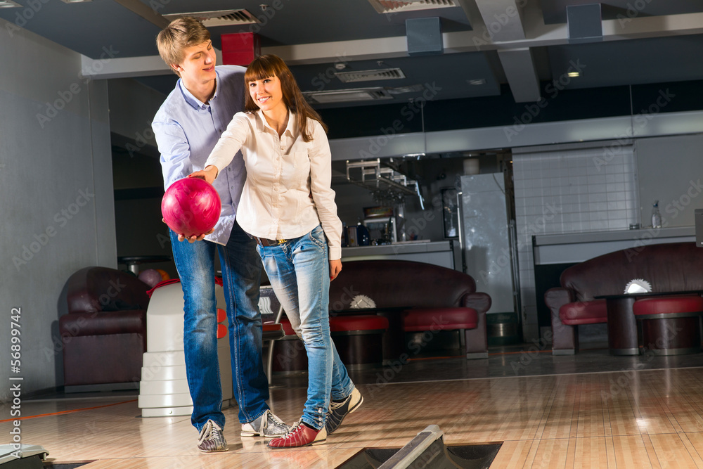 young couple plays bowling