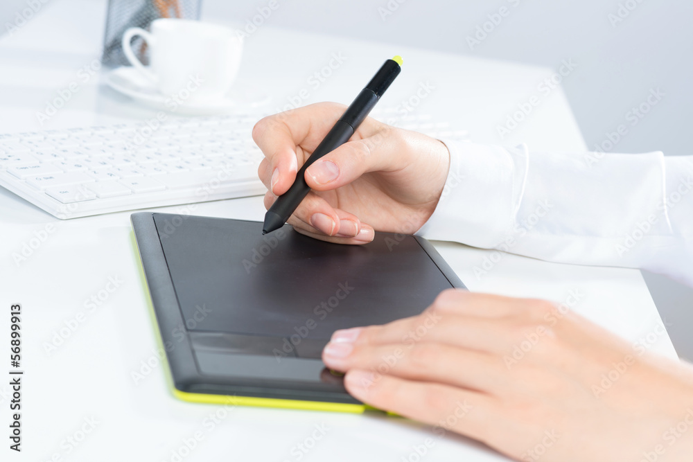 Designer hand drawing a graph on the tablet