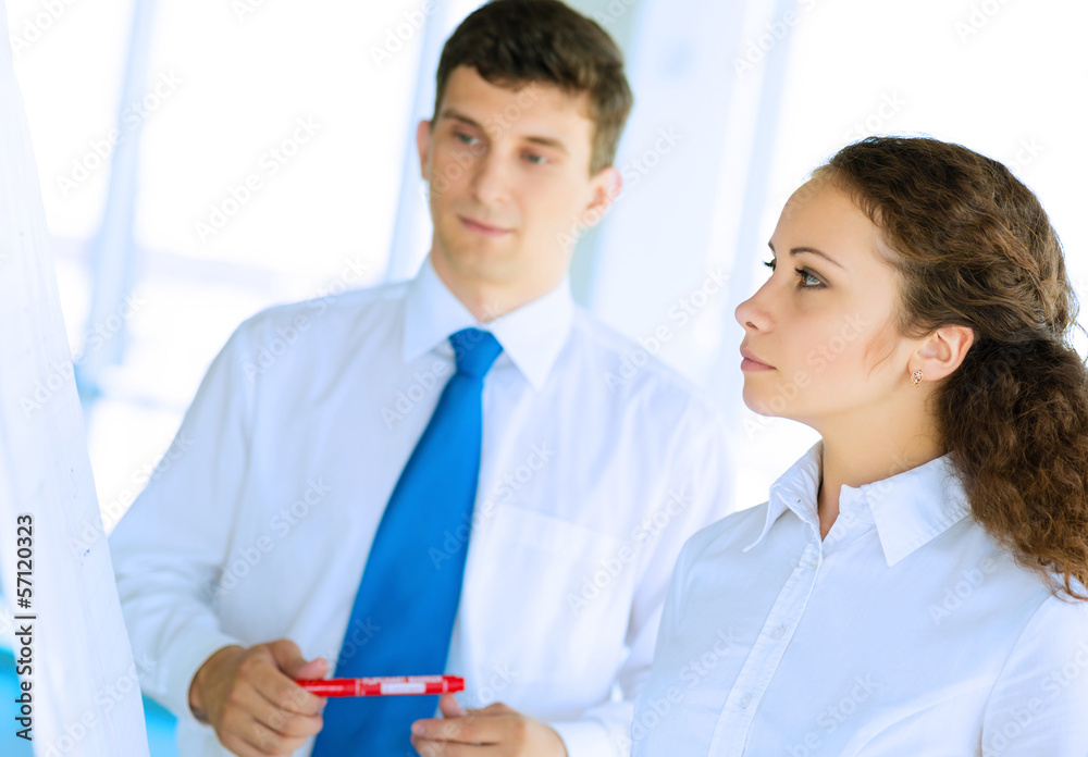 businessmen are meeting near the flipchart