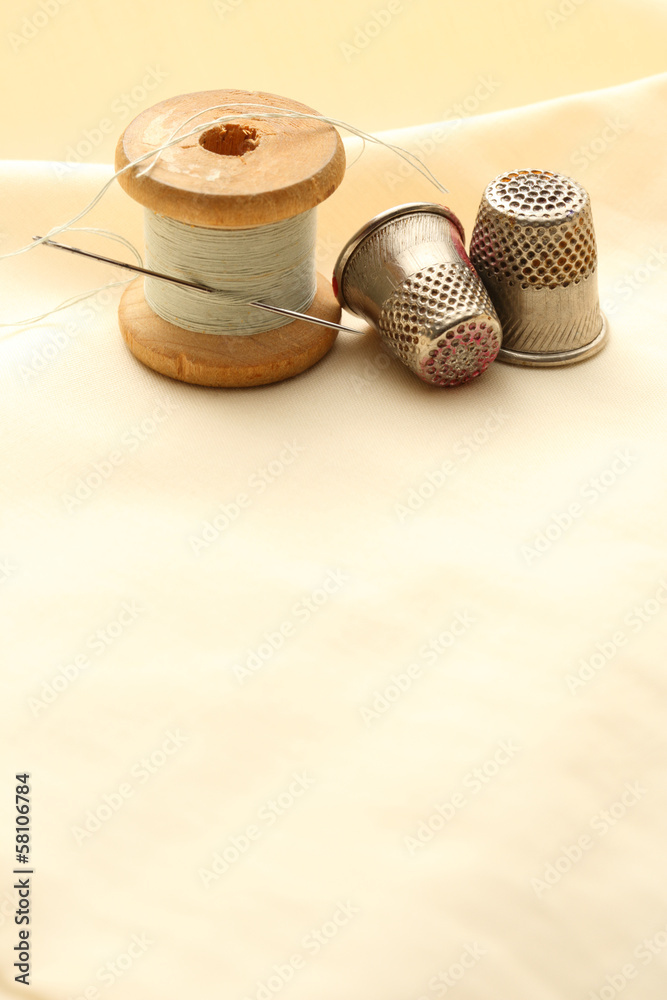 Sewing thimbles, bobbin and needle