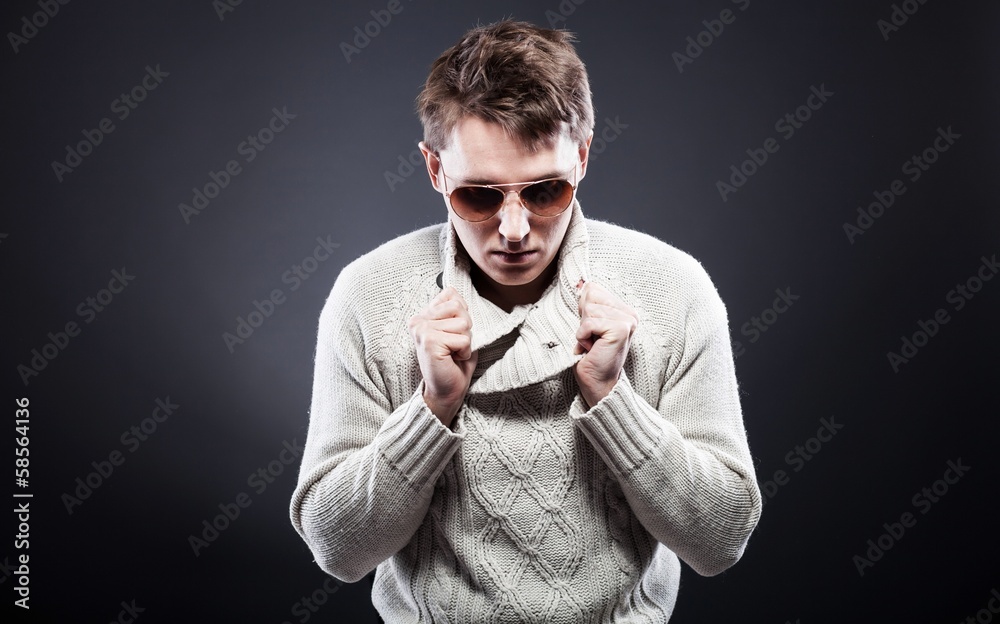 Man in white sweater and sunglasses