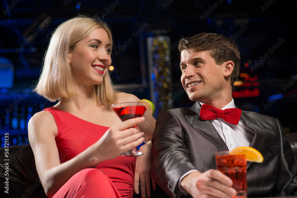 Young couple talking in a nightclub