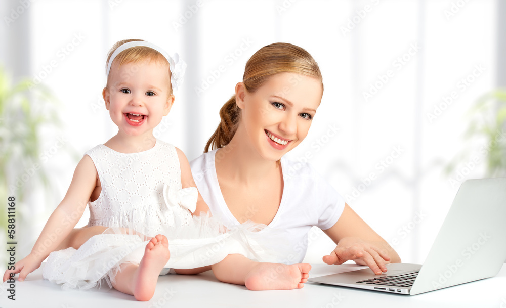 mother and baby at home using laptop computer